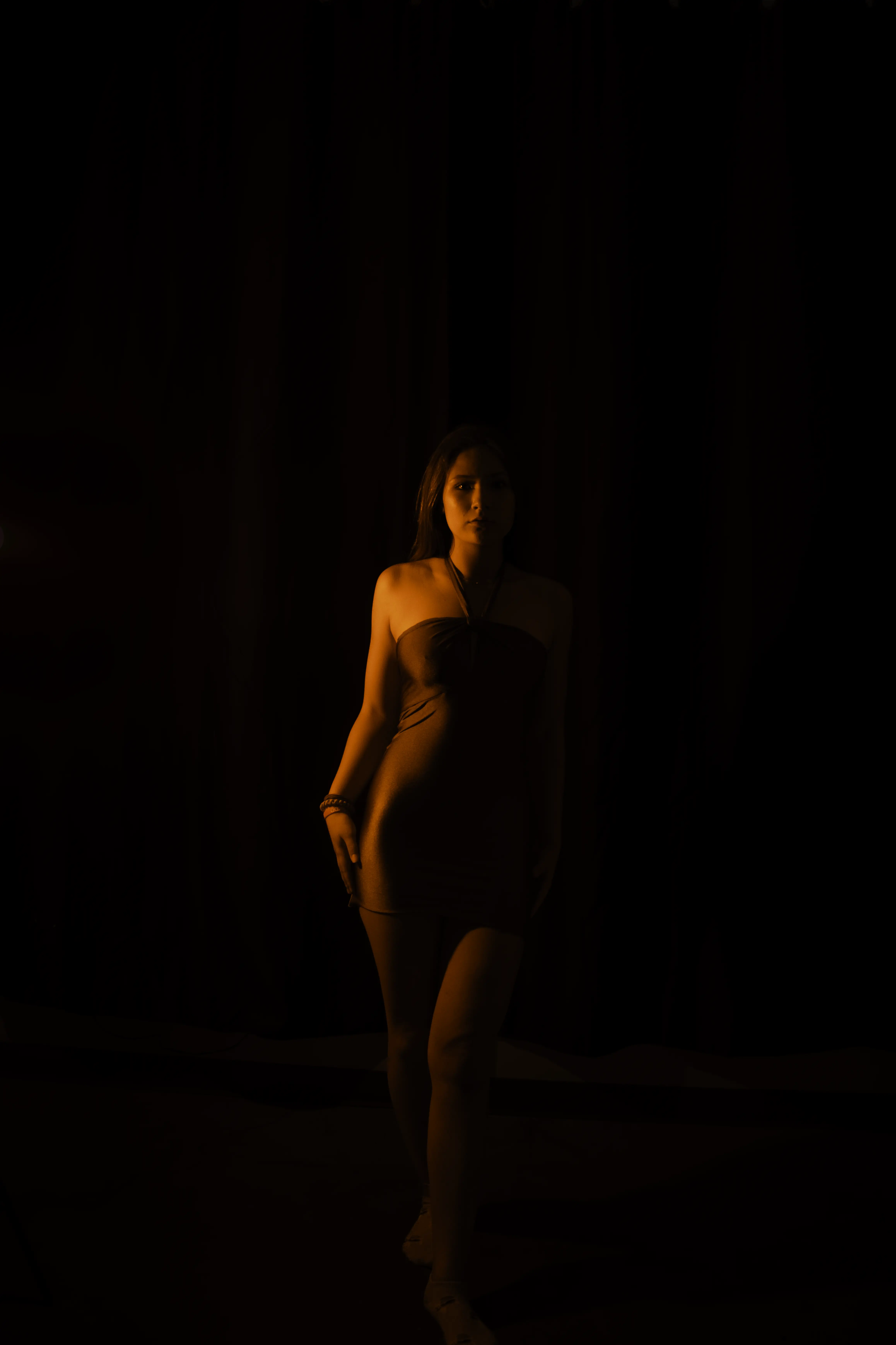 A low-light fashion frame — deliberate shadow, controlled palette